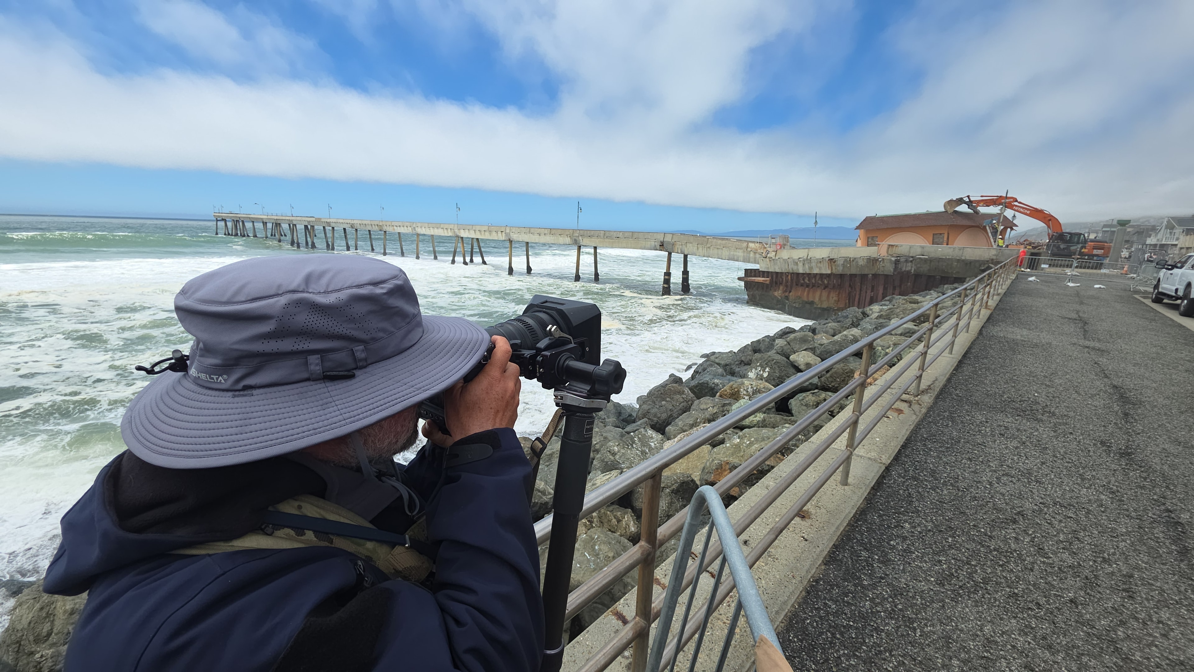 Community photographer documenting the Pacifica Pier from the shoreline