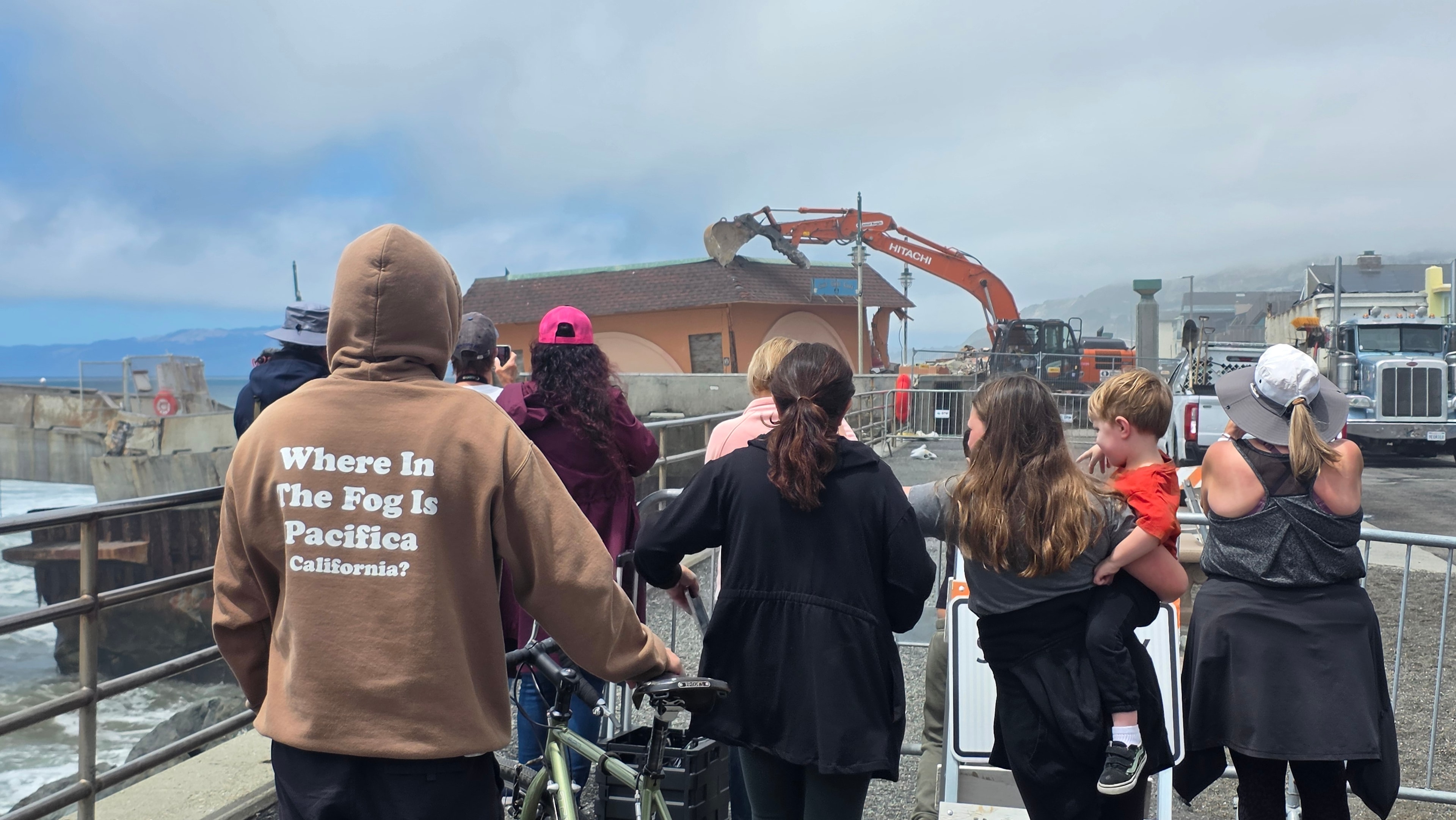 Pacifica community members watching work at the pier